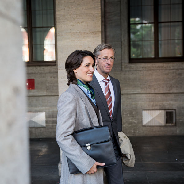 Eine Frau mit einem Laptop geht zusammen mit einem Mann spazieren