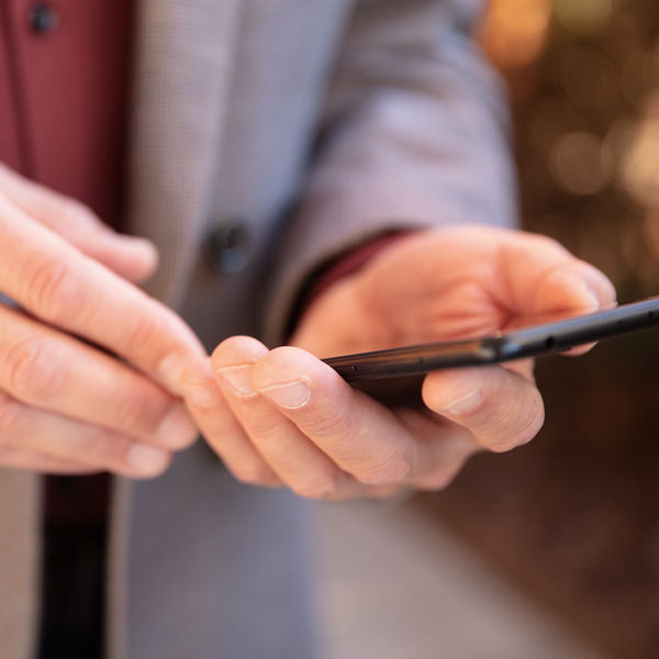 Hände mit Handy in der Hand