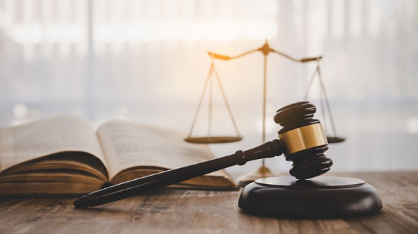 Law theme, mallet of the judge, law enforcement officers, evidence-based cases and documents taken into account