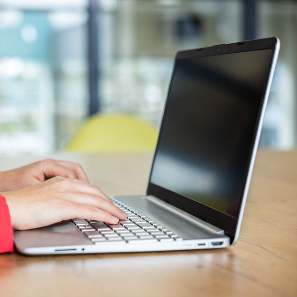 schreibende Hände an einem Laptop